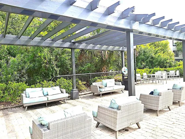a view of a chairs and table in a backyard