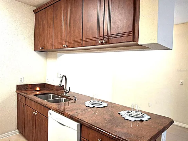 a kitchen with a sink cabinets and a stove top oven