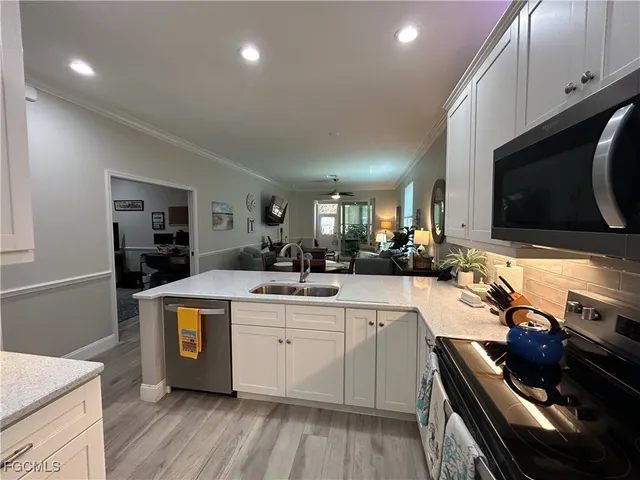 a kitchen with a sink a stove and cabinets