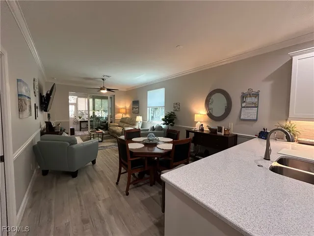 a large living room with a couch and a large mirror with wooden floor