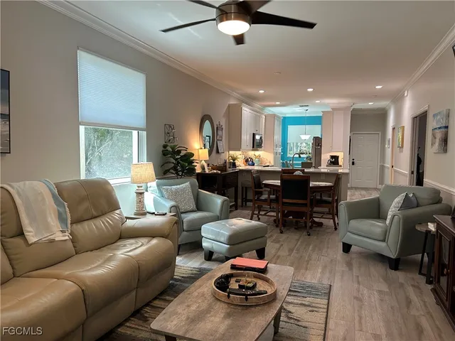 a living room with furniture a fireplace and a window