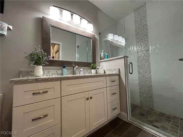 a bathroom with a granite countertop sink vanity granite and a mirror