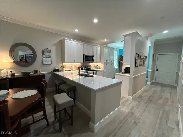 a kitchen with a sink cabinets and wooden floor