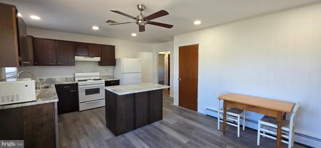 a kitchen with a stove a sink and a refrigerator