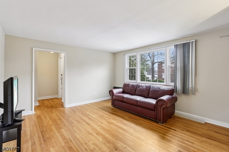 445 Morris Avenue, Unit D11 Springfield, NJ 07081 - Photo 4 of 16 a living room with furniture window and a flat screen tv