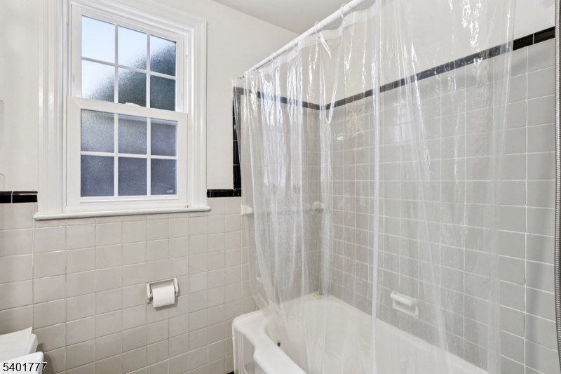 445 Morris Avenue, Unit D11 Springfield, NJ 07081 - Photo 8 of 16 a bathroom with a white bath tub and a shower