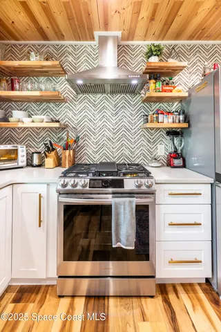 a stove top oven sitting inside of a kitchen