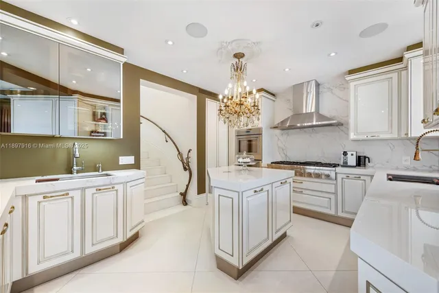 a kitchen with white cabinets and sink
