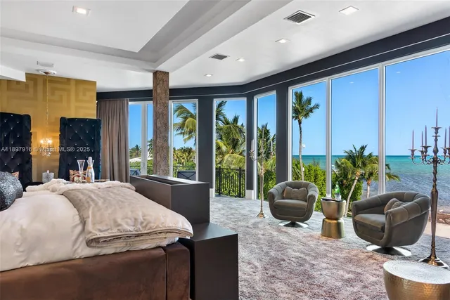 a living room with furniture and large windows