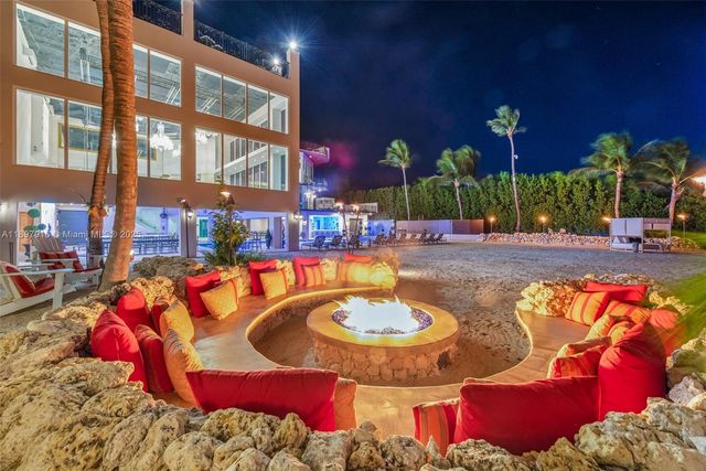 a view of a swimming pool with outdoor seating