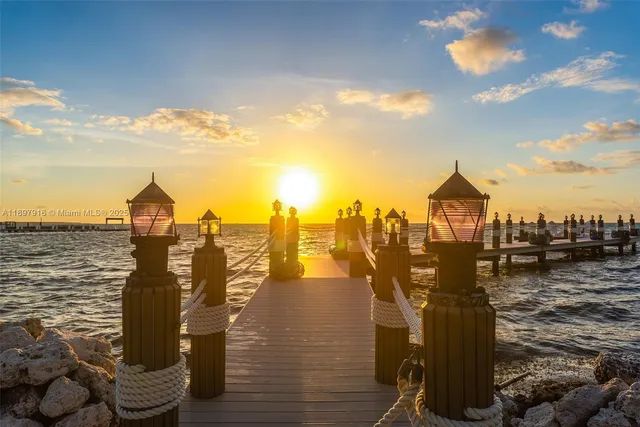 a view of a lake with lawn chairs