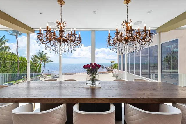 a dining room with table chairs and chandelier