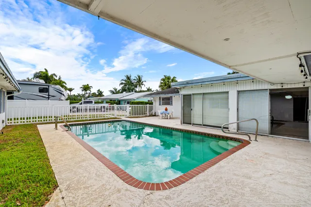 a spacious bedroom with a bed and a chandelier