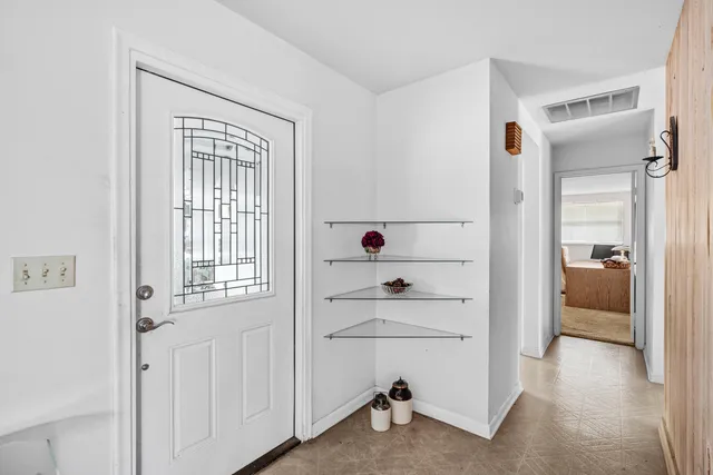 a living room with furniture floor and a flat screen tv