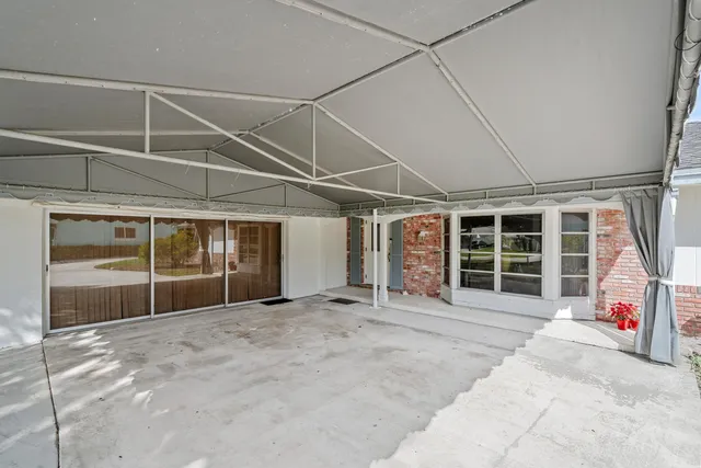a backyard of a house with lots of green space and fountain
