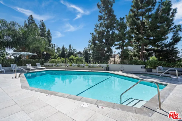 a view of a swimming pool with chairs