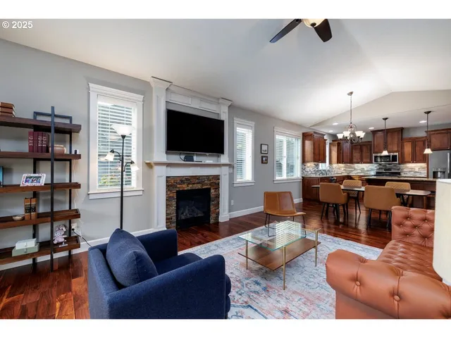 a living room with furniture a fireplace and a flat screen tv
