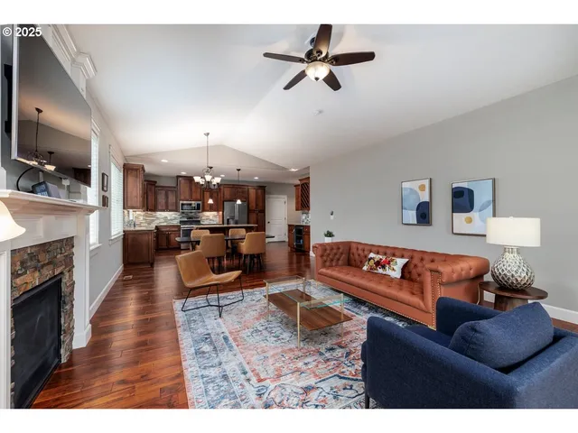 a living room with furniture kitchen view and a fireplace
