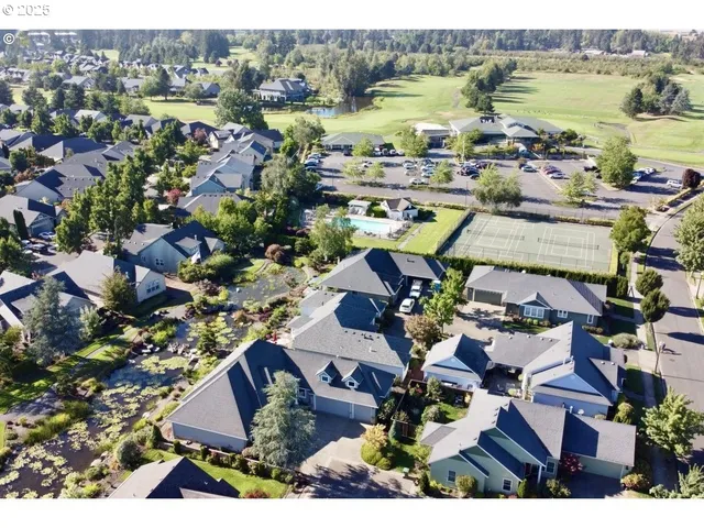 an aerial view of residential house with swimming pool and ocean view