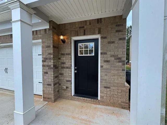 a view of an empty room with a fireplace and a window