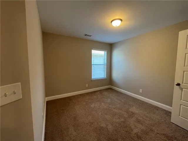 an empty room with closet area