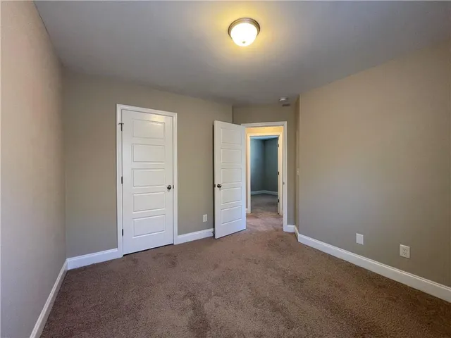 a view of a field with trees in the background