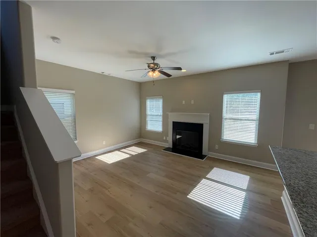 a view of empty room with a fireplace and window