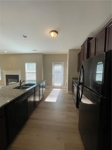 a kitchen with a refrigerator and a stove