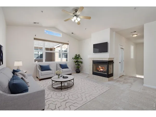 a living room with furniture a fireplace and a chandelier