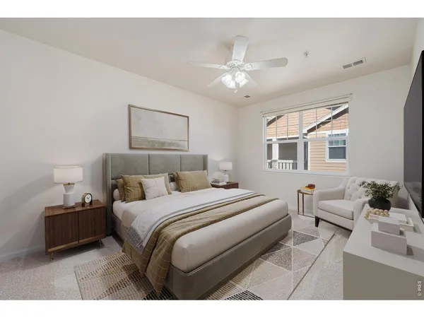 a bedroom with a large bed and a chandelier