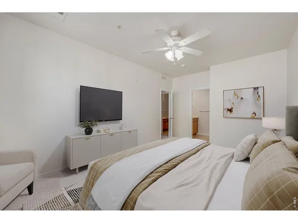 a bedroom with a bed and a flat screen tv