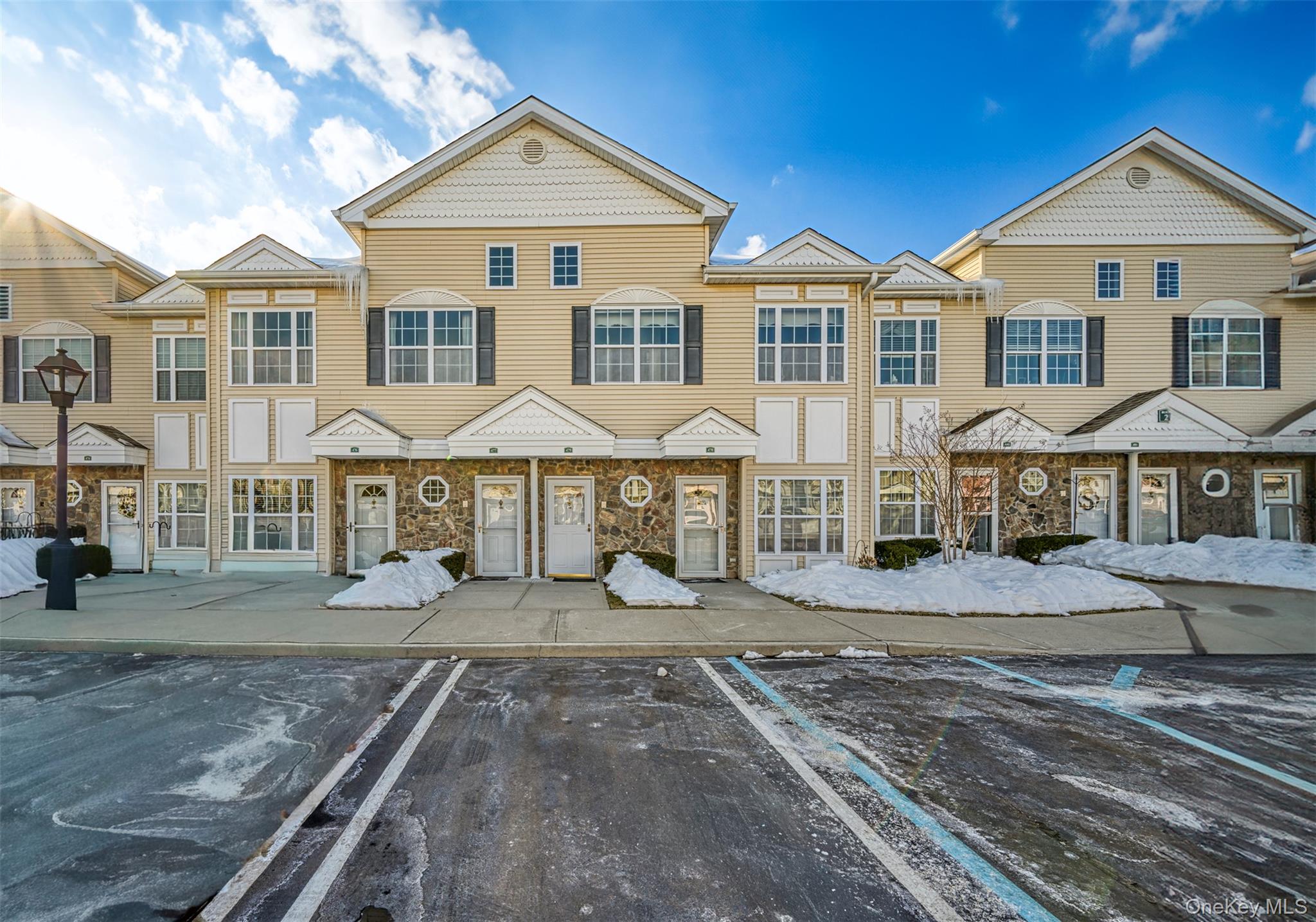 a view of a white house with a yard and sitting space