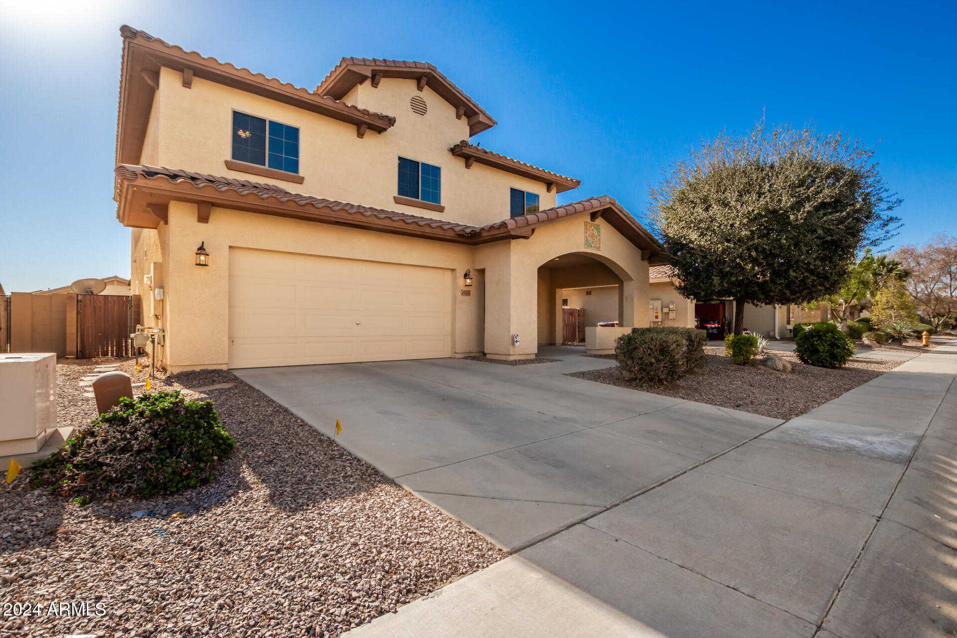 45335 West Rhea Road Maricopa, AZ 85139 - Photo 3 of 52 a front view of a house with a yard