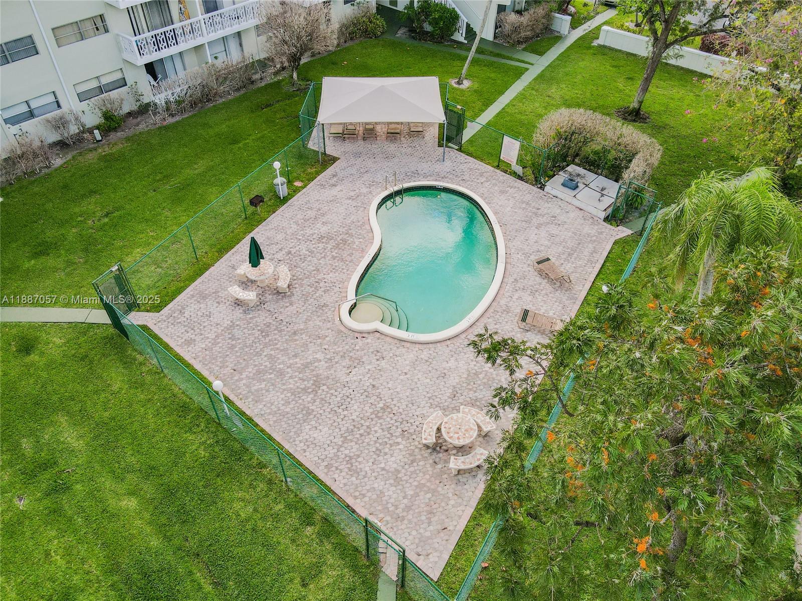 4200 Northwest 3rd Court, Unit 116 Plantation, FL 33317 - Photo 17 of 18 an aerial view of a house with a yard and outdoor seating