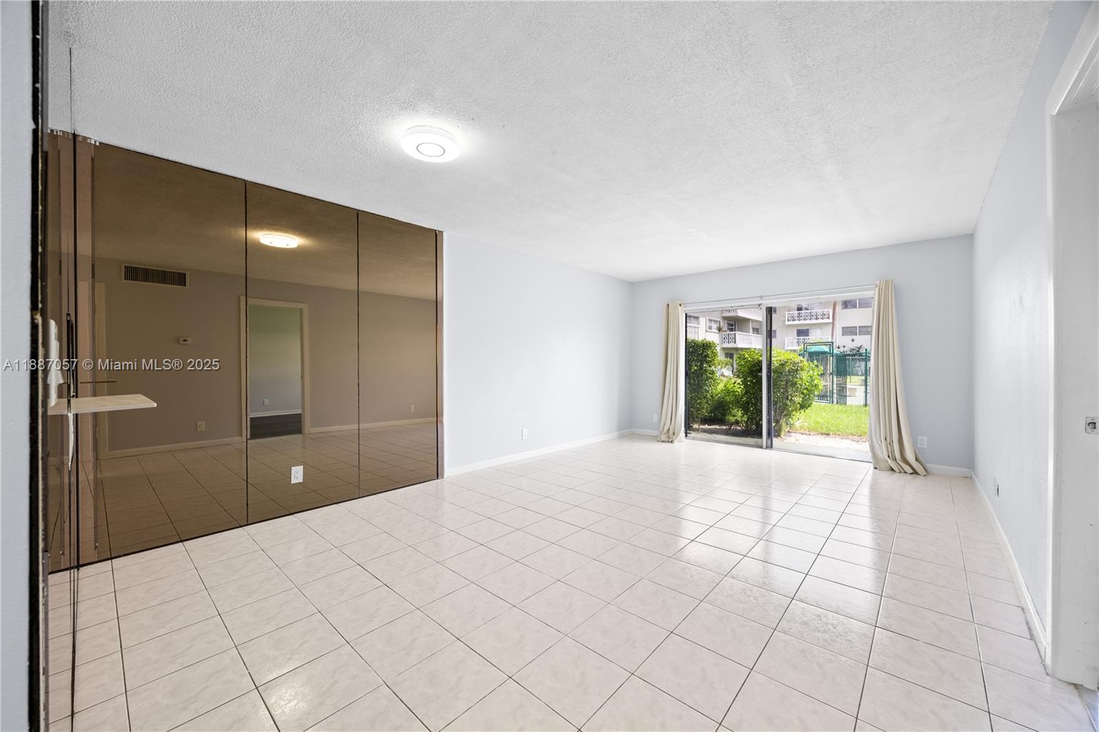 4200 Northwest 3rd Court, Unit 116 Plantation, FL 33317 - Photo 4 of 18 a view of an empty room with a window