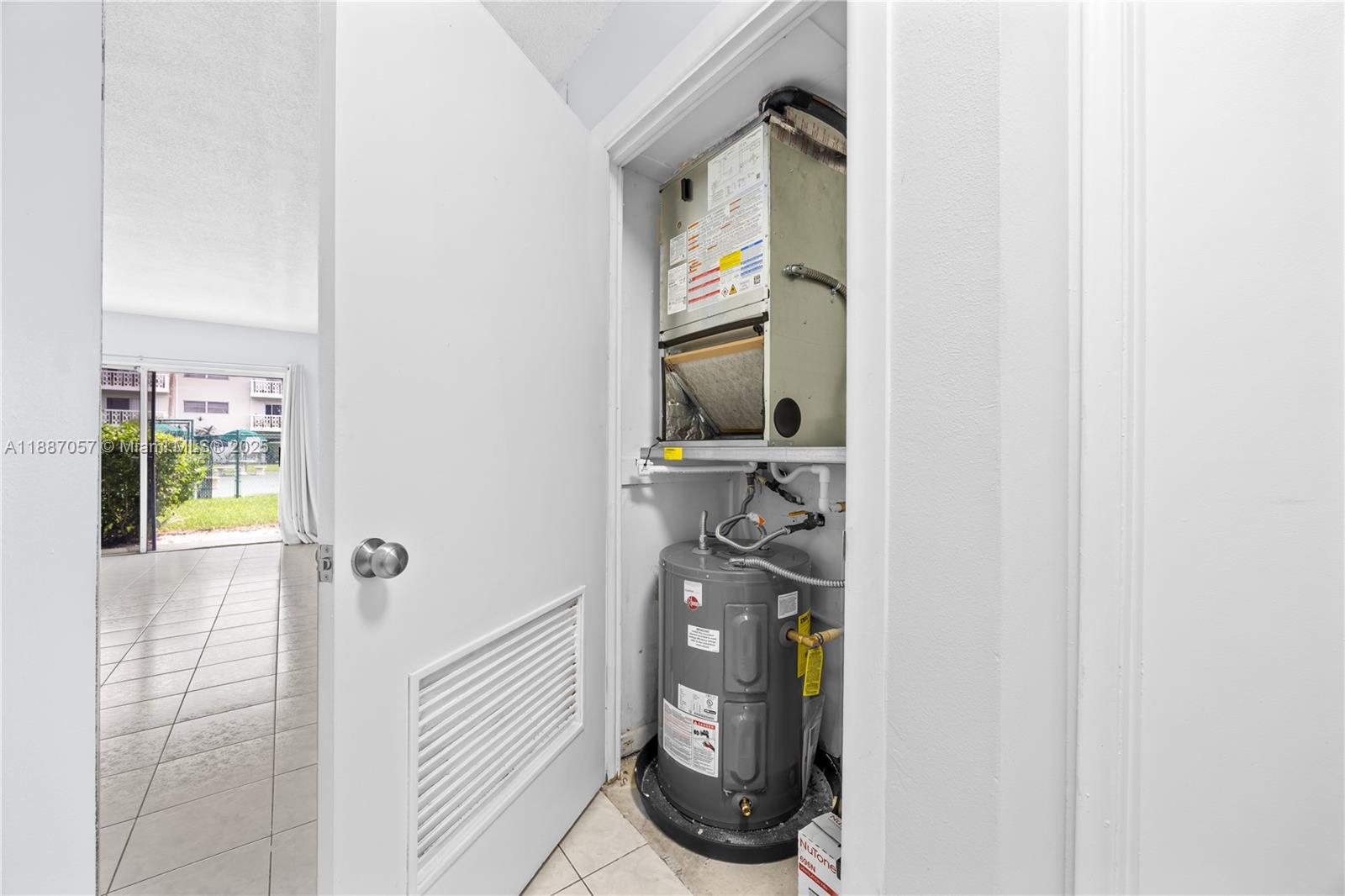 4200 Northwest 3rd Court, Unit 116 Plantation, FL 33317 - Photo 9 of 18 a bathroom with a walk in closet and a window