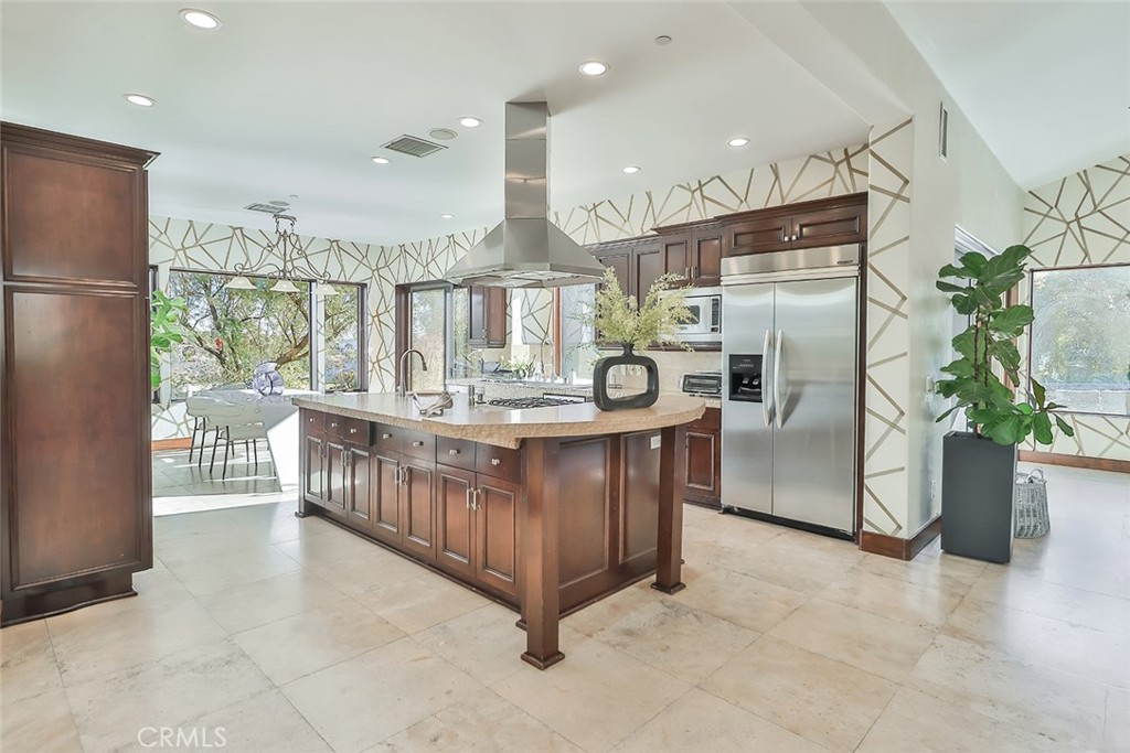 10 Sage Lane Bell Canyon, CA 91307 - Photo 11 of 65 a kitchen with stainless steel appliances kitchen island granite countertop a refrigerator a stove a oven and a sink with large windows