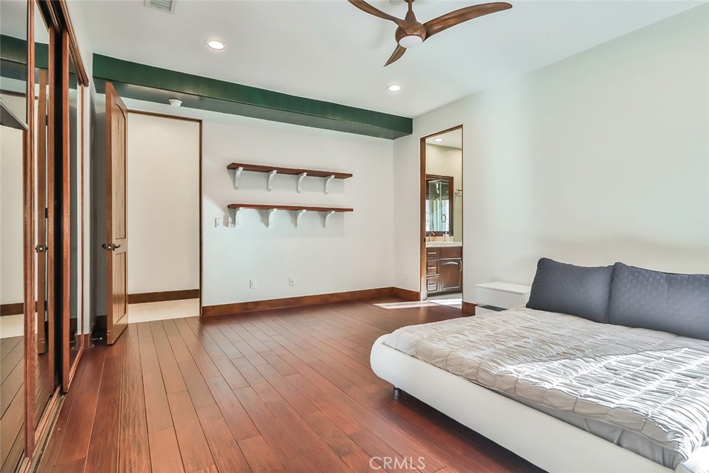 10 Sage Lane Bell Canyon, CA 91307 - Photo 22 of 65 a bedroom with a bed and wooden floor