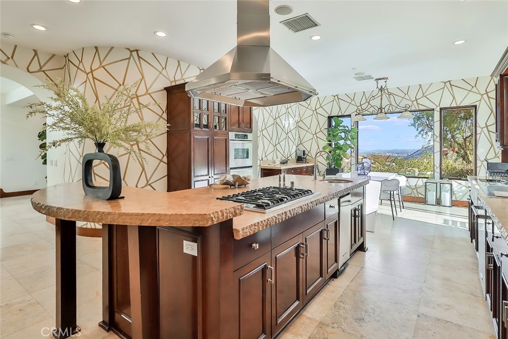 10 Sage Lane Bell Canyon, CA 91307 - Photo 10 of 65 a kitchen with stainless steel appliances granite countertop a stove a sink dishwasher and cabinets with wooden floor