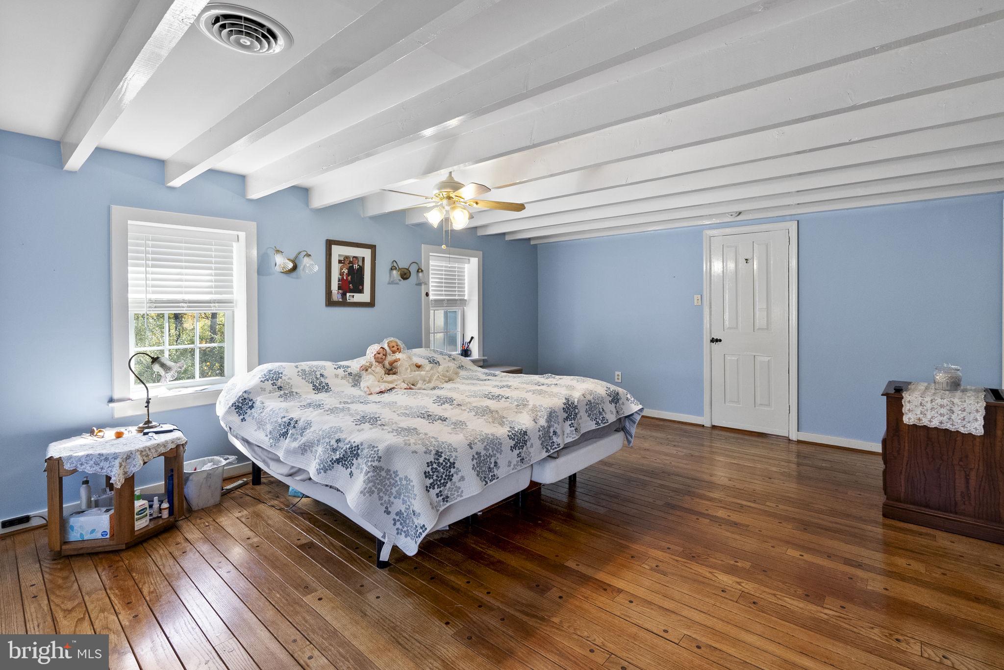 111 Mine Run Road Schwenksville, PA 19473 - Photo 47 of 60 a bedroom with a bed and wooden floor