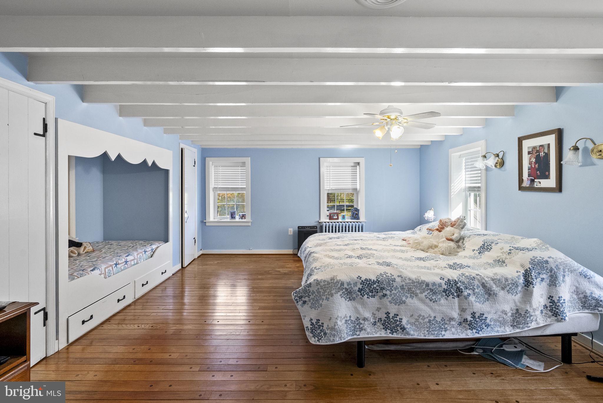 111 Mine Run Road Schwenksville, PA 19473 - Photo 48 of 60 a bedroom with a bed and wooden floor