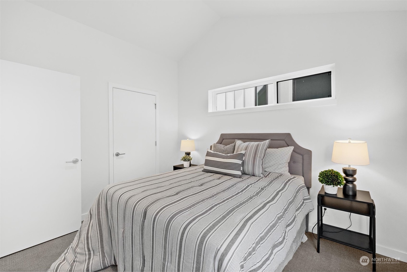2119 South Walker Street, Unit B Seattle, WA 98144 - Photo 19 of 23 a bedroom with a bed and a lamp