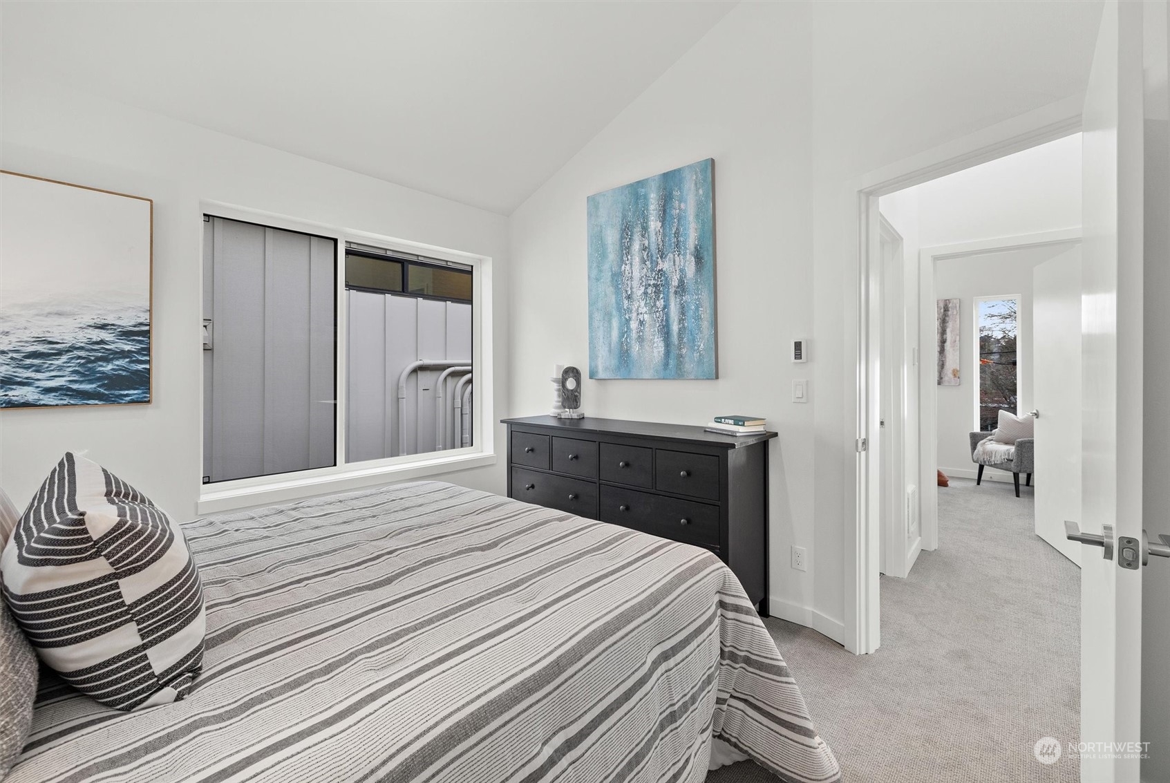 2119 South Walker Street, Unit B Seattle, WA 98144 - Photo 20 of 23 a bedroom with a bed and a chandelier