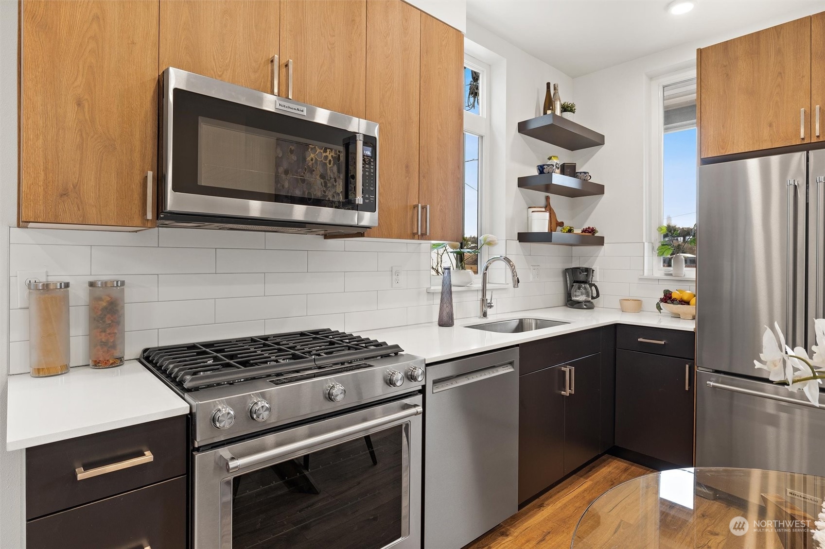 2119 South Walker Street, Unit B Seattle, WA 98144 - Photo 4 of 23 a kitchen with stainless steel appliances a stove a sink and a microwave