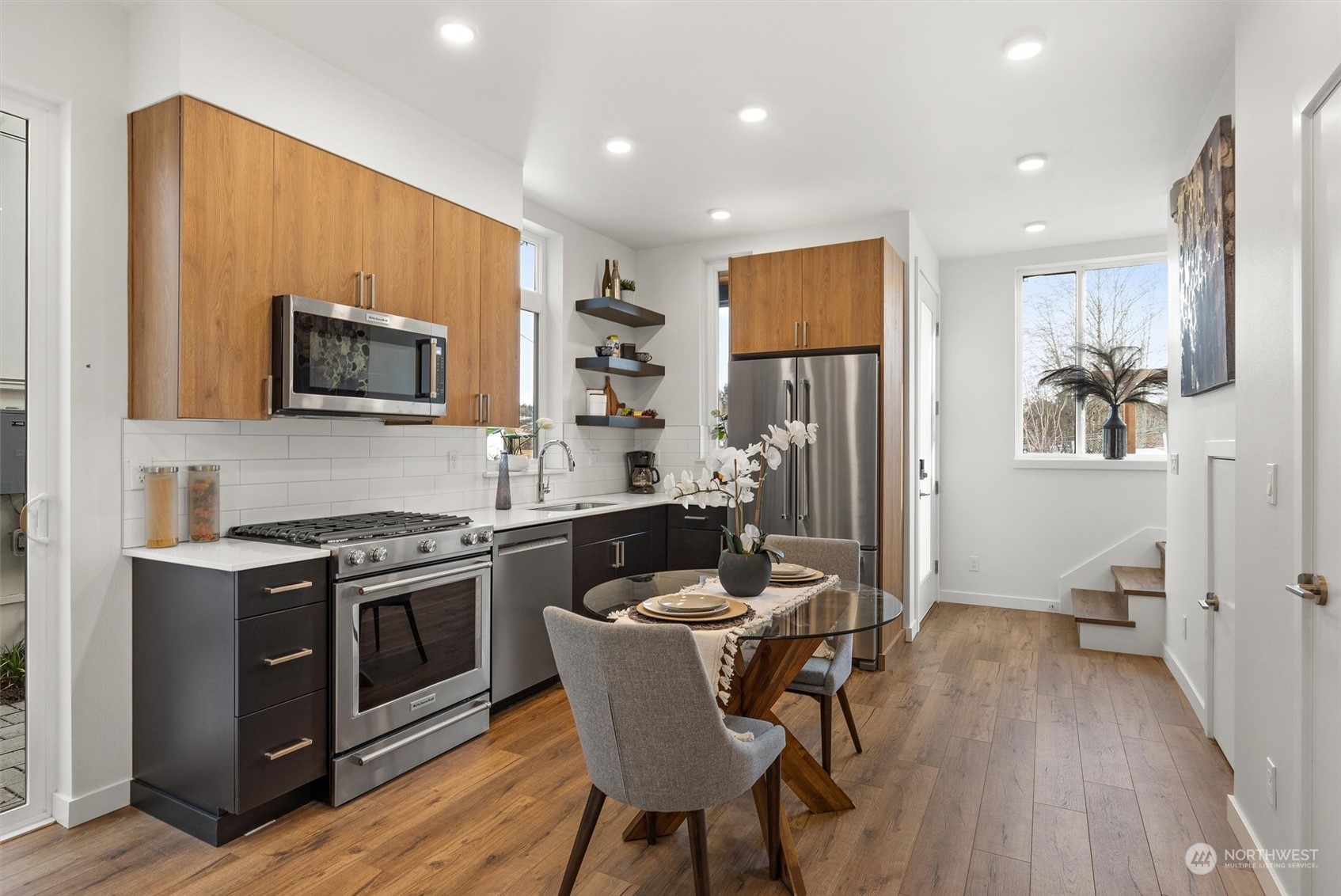 2119 South Walker Street, Unit B Seattle, WA 98144 - Photo 5 of 23 a kitchen with stainless steel appliances granite countertop a stove top oven a sink dishwasher a dining table and chairs with wooden floor