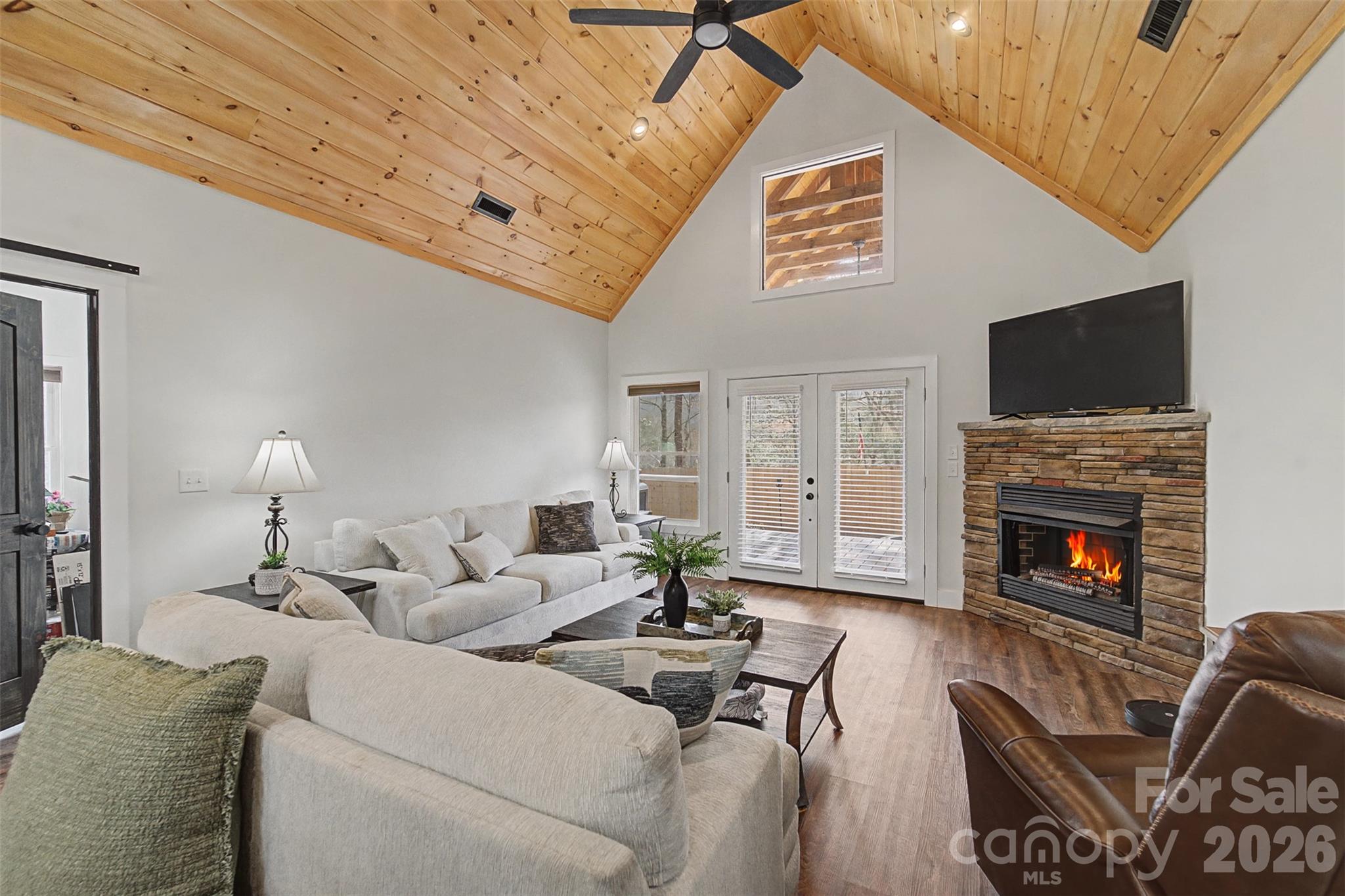 79 Abbey View Road Bryson City, NC 28713 - Photo 14 of 48 a living room with furniture a flat screen tv and a fireplace