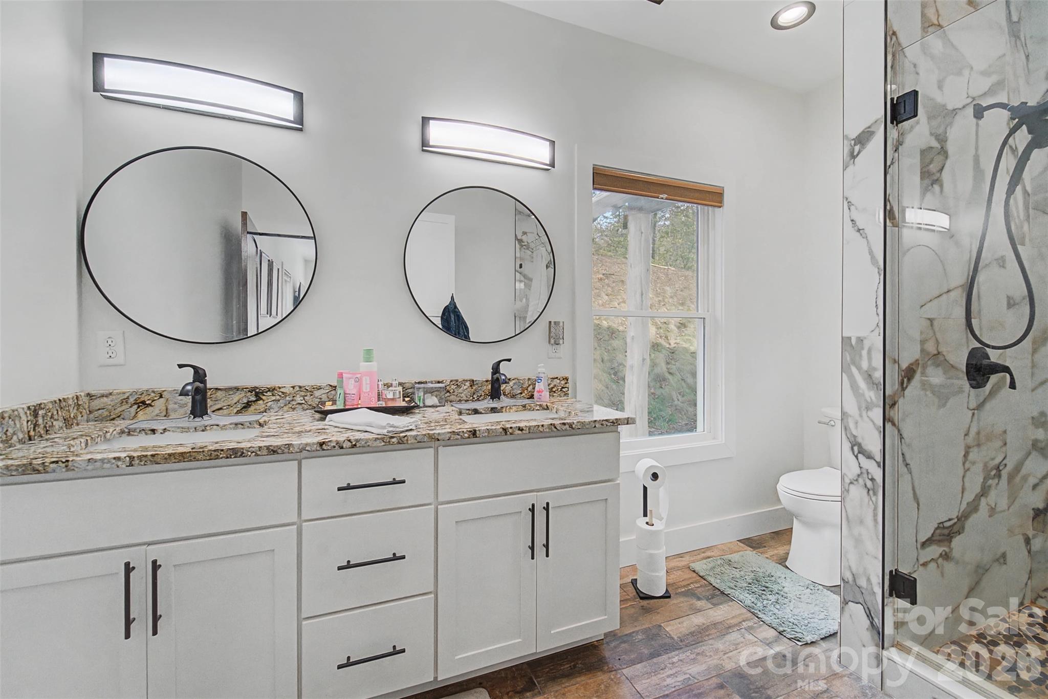 79 Abbey View Road Bryson City, NC 28713 - Photo 20 of 48 a bathroom with a granite countertop toilet sink and mirror