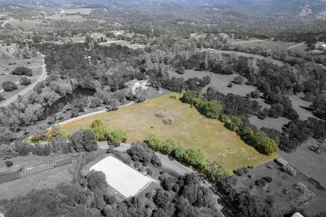 an aerial view of a house with a yard