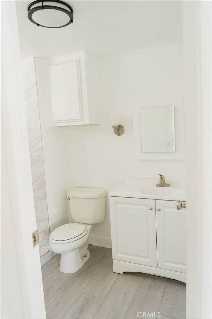 995 Pomona Road, Unit 33 Corona, CA 92882 - Photo 14 of 25 a bathroom with a sink a toilet and vanity