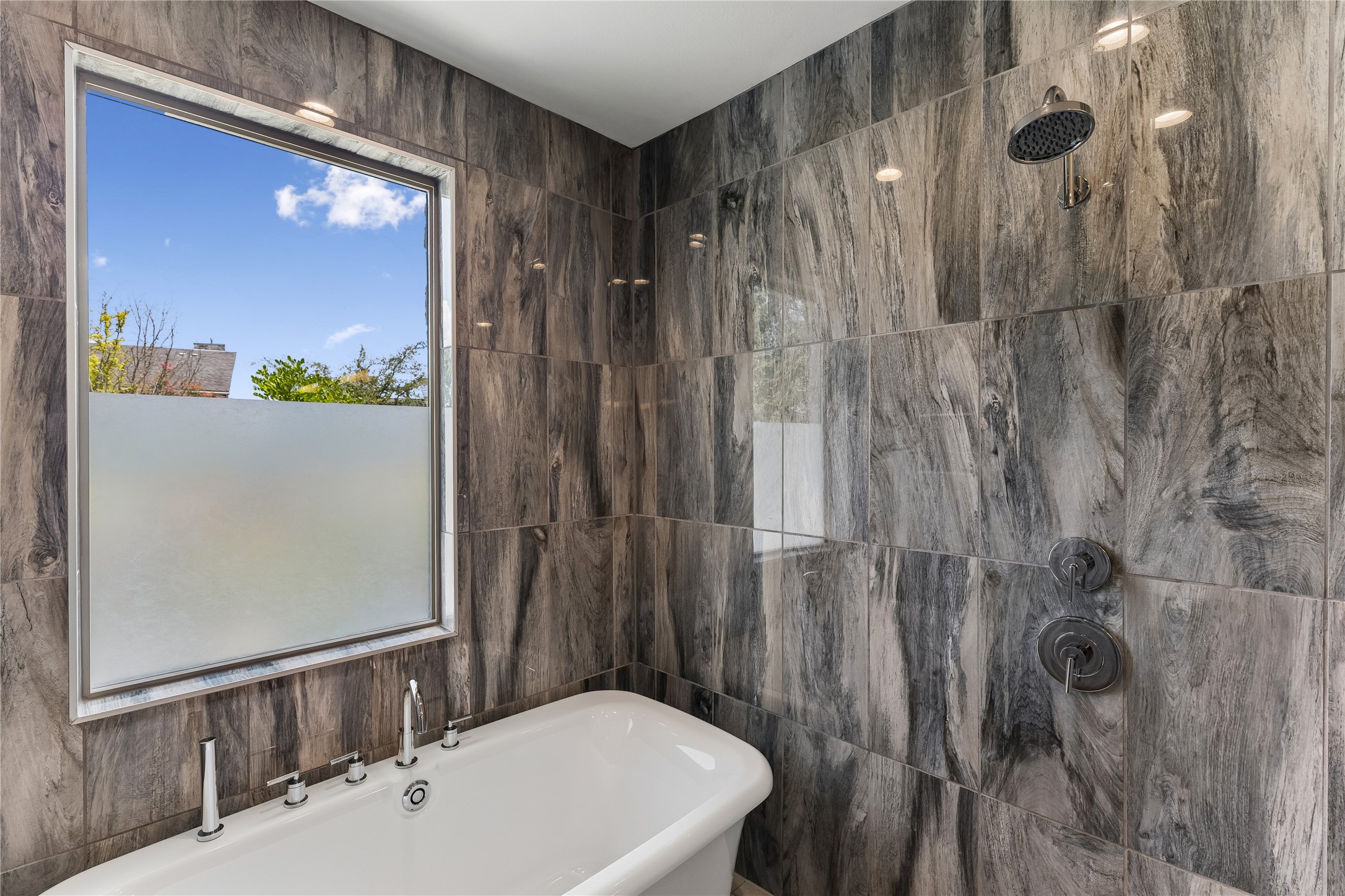 8110 Ranch Road 2222, Unit 68 Austin, TX 78730 - Photo 10 of 24 Indulge in a luxurious primary bathroom, complete with a freestanding soaking tub and an elegant tiled shower.